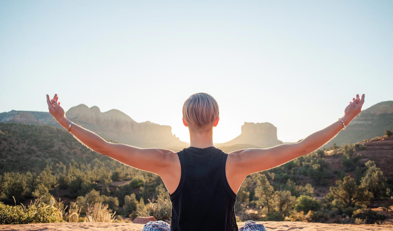 Woman in desert with arms outstretched